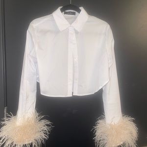 Akira white blouse with blush feather cuffs